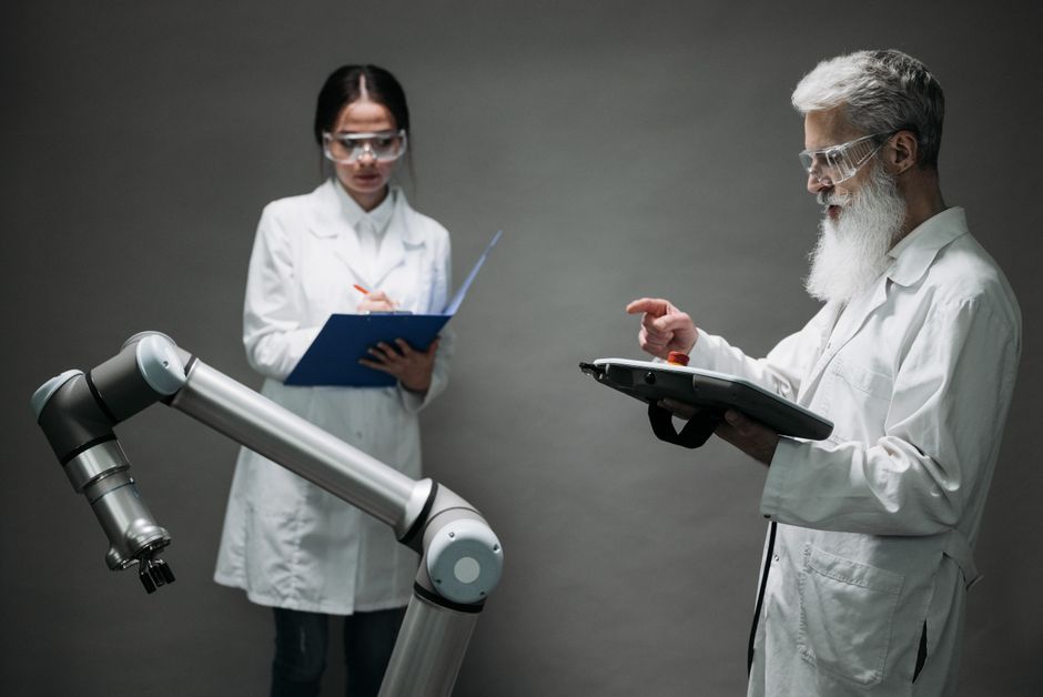 Scientists in a lab working with a robot, focusing on technological innovation and development.